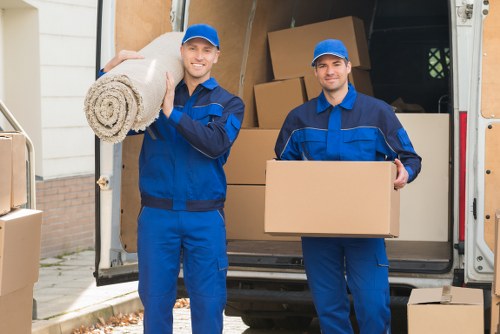 Professional movers planning access in a Bow apartment block