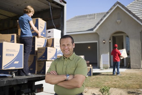 Furniture and packed boxes prepared for relocation in Bow