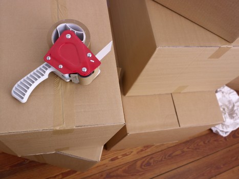Unpacking boxes in a Bow flat with careful room-by-room organisation