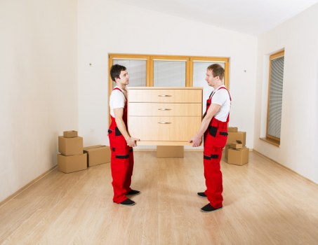 Loading furniture into a van on a Bow street